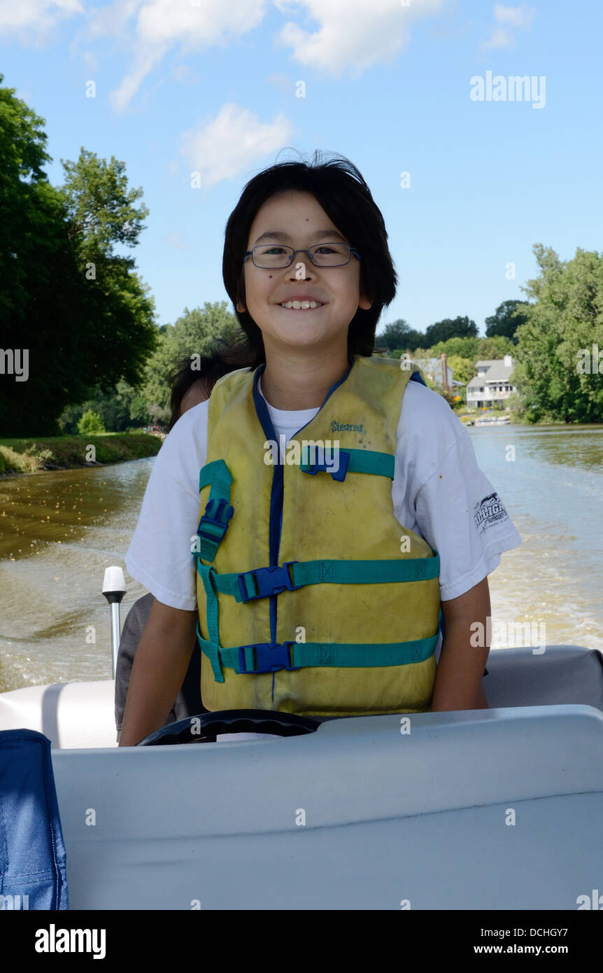 Vater führt zehn Jahre alten Sohn Ponton-Boot fahren. Stockfoto