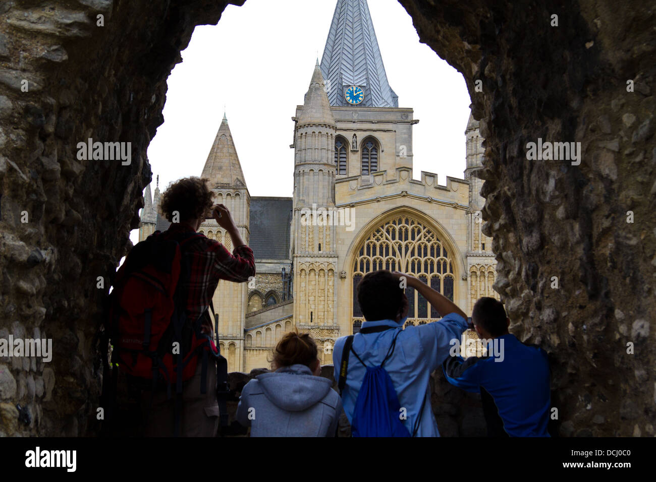 Bild von Besuchern fotografieren Rochester Kathedrale durch ein Fenster in eine Steinmauer an einem grauen Sommertag Stockfoto