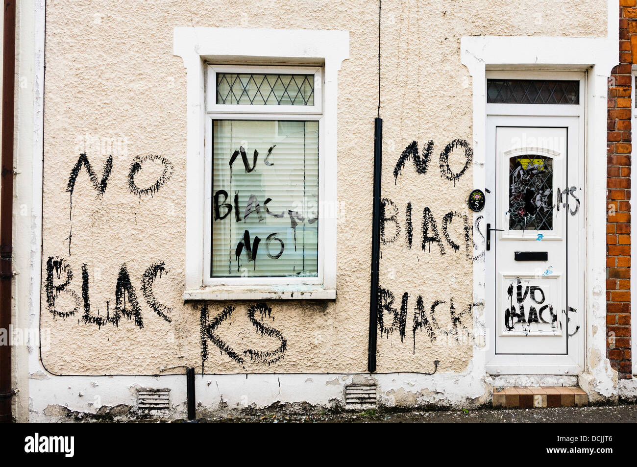Belfast, Nordirland, Vereinigtes Königreich. 19. August 2013 - rassistische Graffiti an den Wänden und Fenstern geschrieben wurde zerschlagen, auf ein Haus, das vor kurzem von zwei nigerianischen Männer in Belfast besetzt. Bildnachweis: Stephen Barnes/Alamy Live-Nachrichten Stockfoto