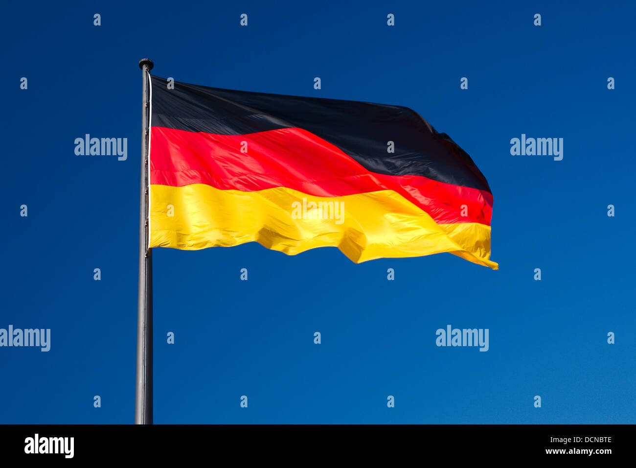 Nationalflagge von Deutschland gegen den blauen Himmel als Hintergrund Stockfoto