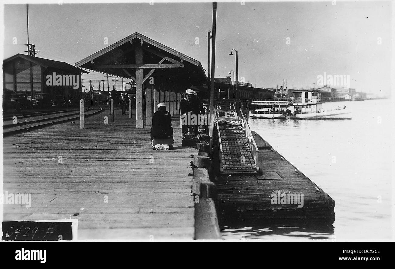Dieses Foto zeigt einen Blick auf die Landung der Fifth Street in Long Beach, Kalifornien, mit Blick nach Norden. Es beleuchtet die Ufergegend mit Booten, die entlang des Piers angedockt werden, und die Landschaft des Hafens von Long Beach. Stockfoto