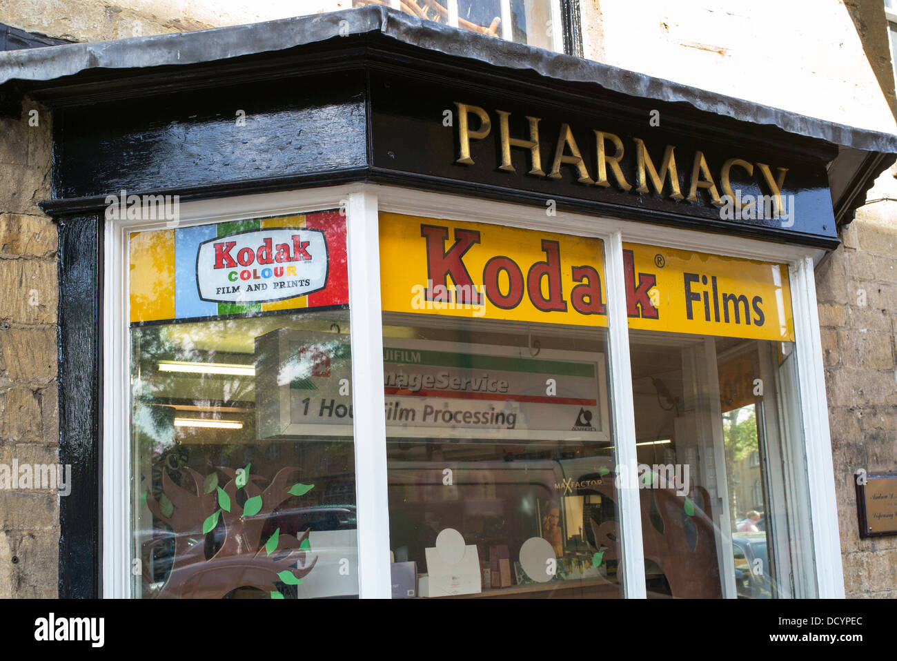 Alte Werbung für Kodak Filme in einem Fenster der Apotheke. Moreton in Marsh, Cotswolds, Gloucestershire, England Stockfoto