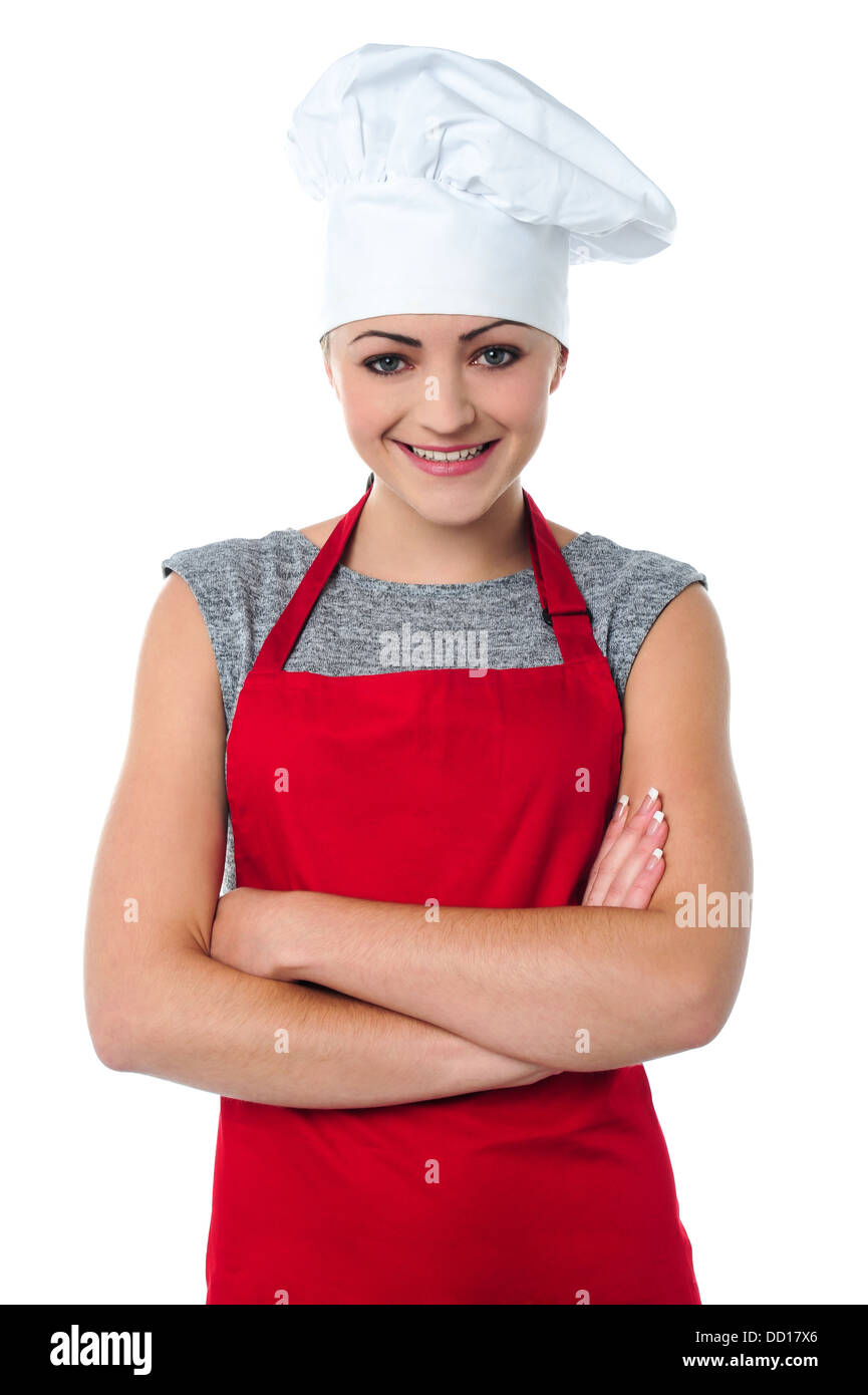 Wunderschöne junge weibliche Bäcker tragen weiße Haube. Stockfoto