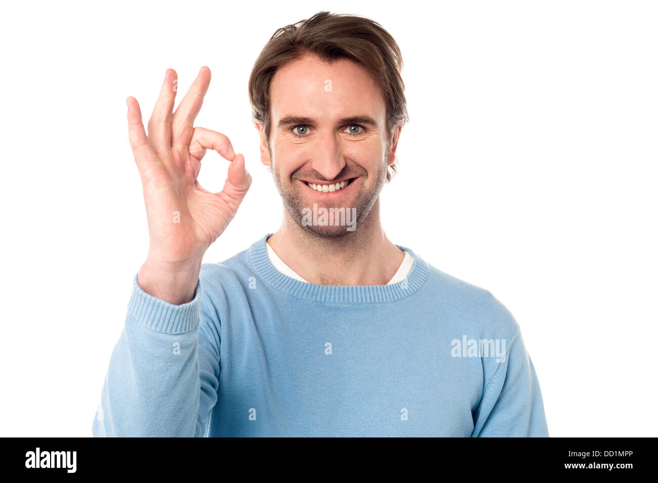 Hübscher junger Mann zeigt "OK" Zeichen über weiß Stockfoto