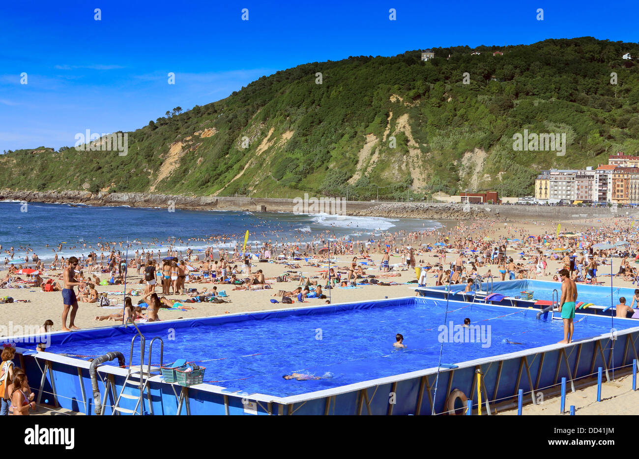 Schwimmbad im Einsatz auf einem überfüllten Gros Strand während des Sommers in San Sebastian, Spanien Stockfoto