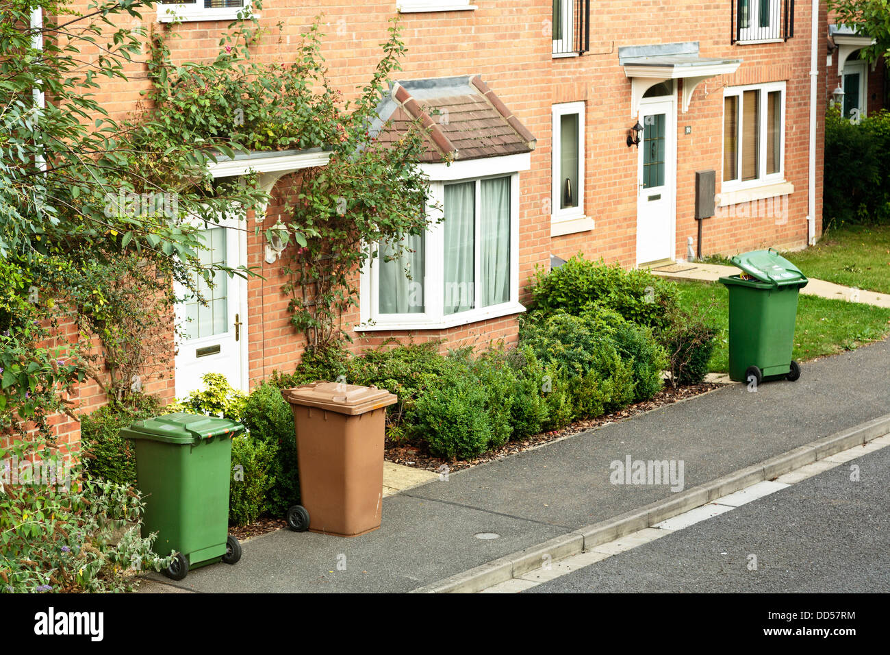 Recycling-grüne und braune Garten Abfall Behälter vor den Häusern bereit für Sammlung, Hampton Vale, Peterborough, England Stockfoto