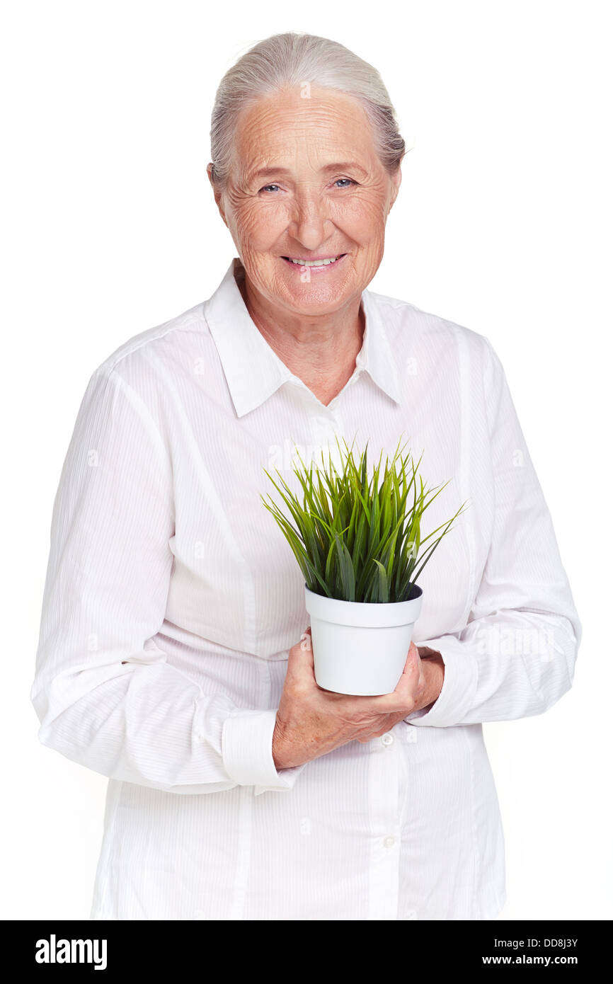 Porträt von älteren Weibchen mit Grünpflanze Blick in die Kamera Stockfoto