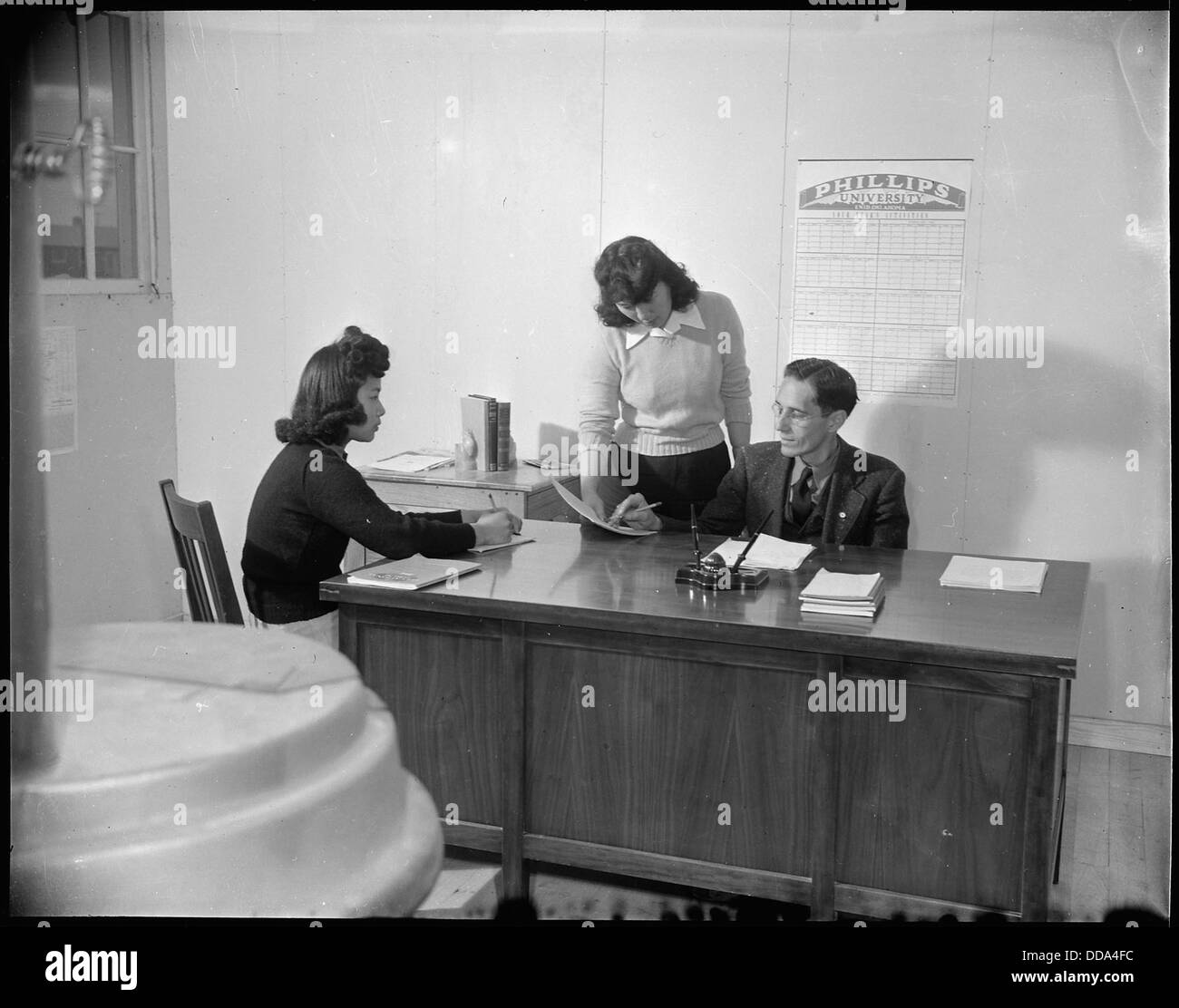Mr. H. Zeigler, der Grundschulleiter im Rohwer Relocation Center in McGehee, Arkansas, wird während der Internierung japanischer Amerikaner in seinem Büro gezeigt. Stockfoto