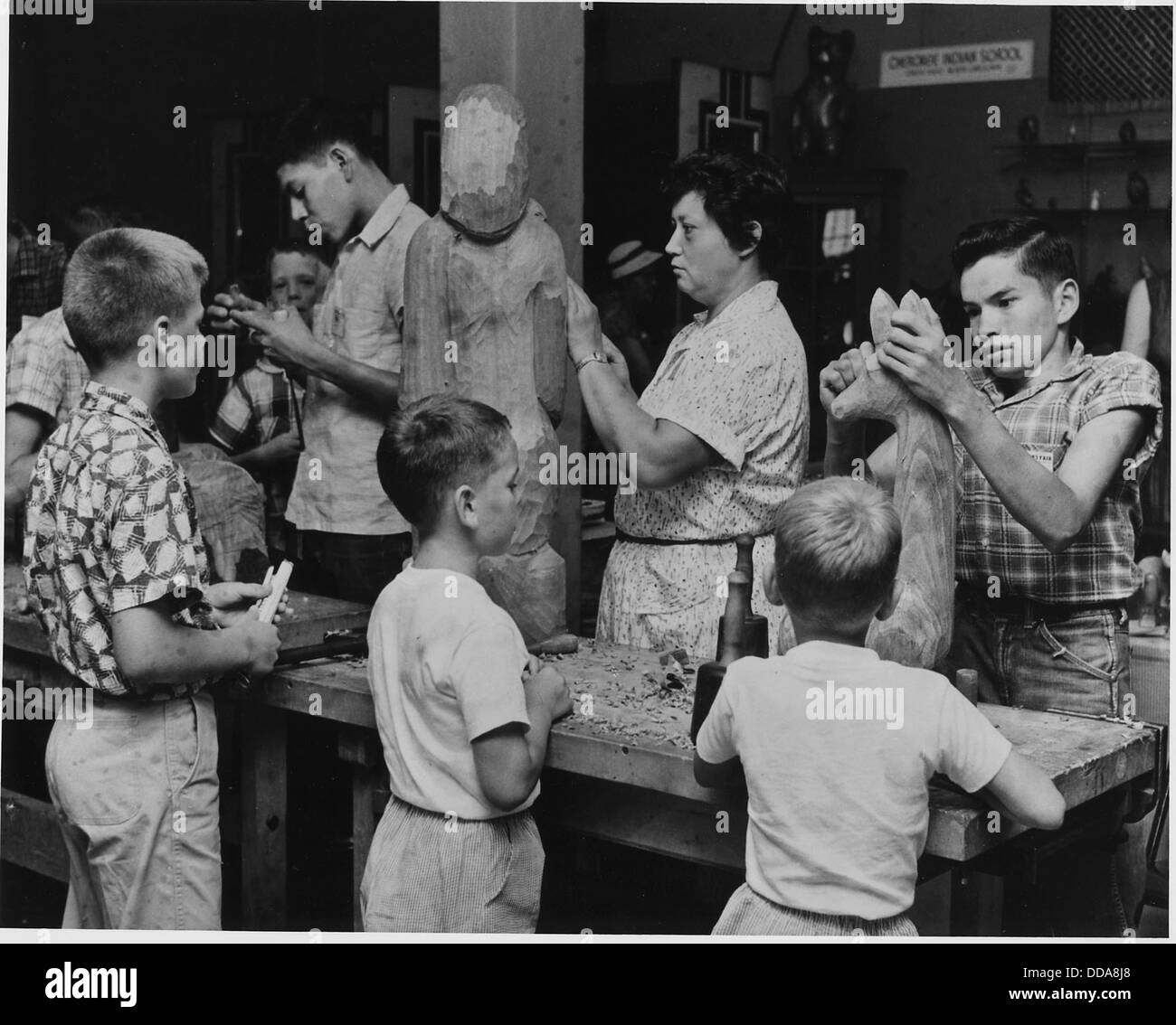 Auf der Craftsmen's Fair der Cherokee Indian Reservation in North Carolina beobachten Besucher Amanda Crowe, eine bekannte Cherokee-Künstlerin, ihre Fähigkeiten. Die Veranstaltung zeigt die Handwerkskunst und kulturellen Traditionen der Cherokee. Stockfoto