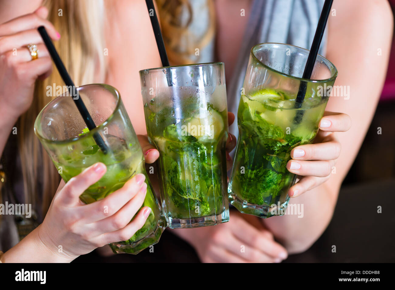 Junge Frauen in Café, Bar oder Restaurant, Cocktails trinken und die Freizeit genießen Stockfoto