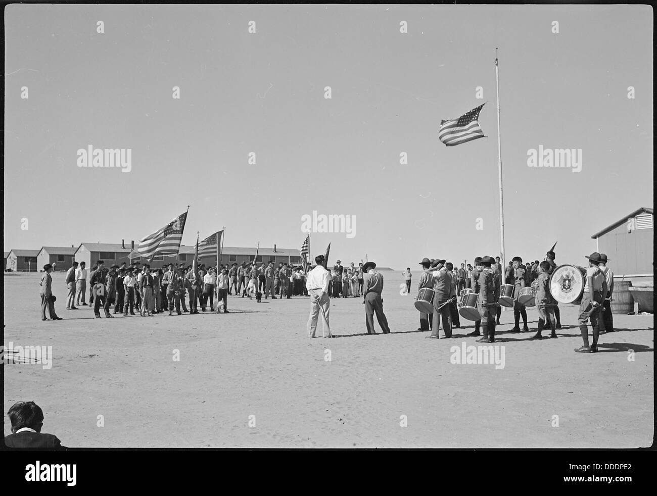 Ein Foto aus dem Granada Relocation Center in Amache, Colorado, mit einer Szene aus der Boy Scout Memorial Day Parade. Das Bild zeigt Evakuierte und Einzelpersonen aus dem Zentrum, die während eines bedeutenden historischen Ereignisses an der Parade teilnehmen. Stockfoto