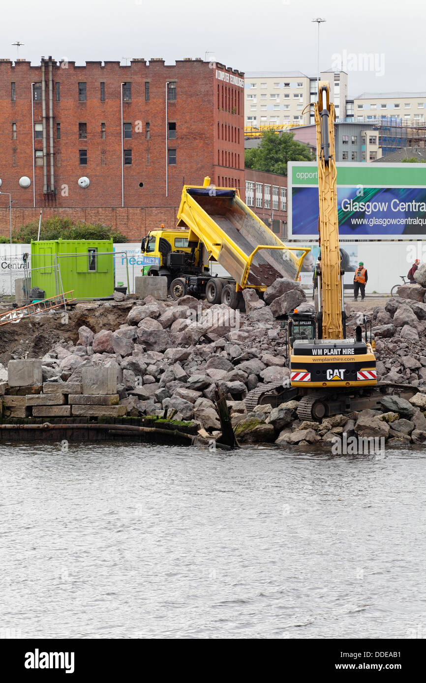 Arbeiten zur Reparatur des eingestürzten Gehwegs am Anderston Quay am Fluss Clyde mit einem Bagger in Glasgow, Schottland, Großbritannien Stockfoto