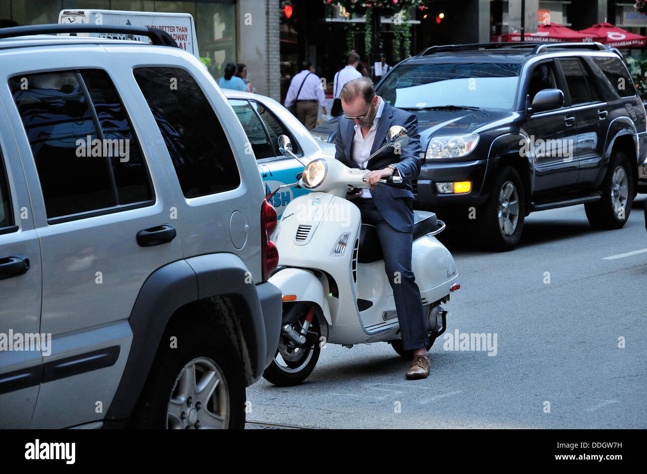 Businessman Riding Vespa Scooter In Stockfotos Businessman Riding
