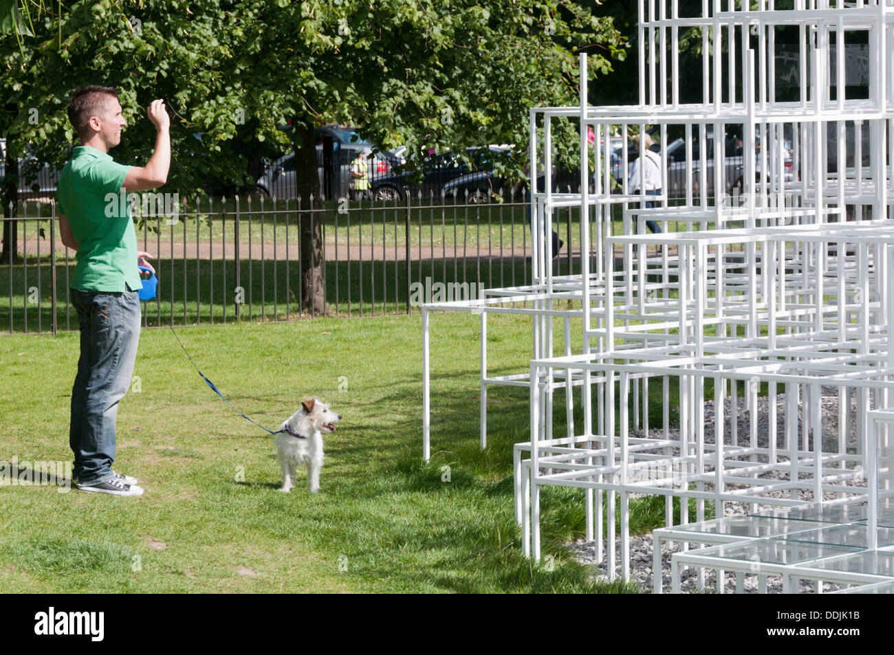Ein Mann (und seinem Hund) fotografieren 2013 Serpentine Gallery Summer Pavilion entworfen von dem japanischen Architekten Sou Fujimoto. Stockfoto