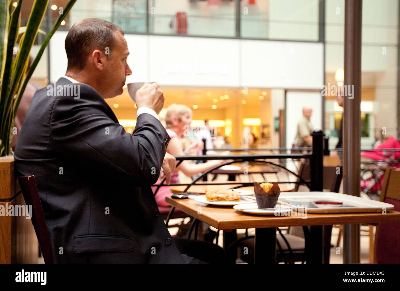 Geschäftsmann mit einer Kaffeepause in eine Café-Bar, Grand Arcade Shopping Centre, Cambridge England UK Stockfoto