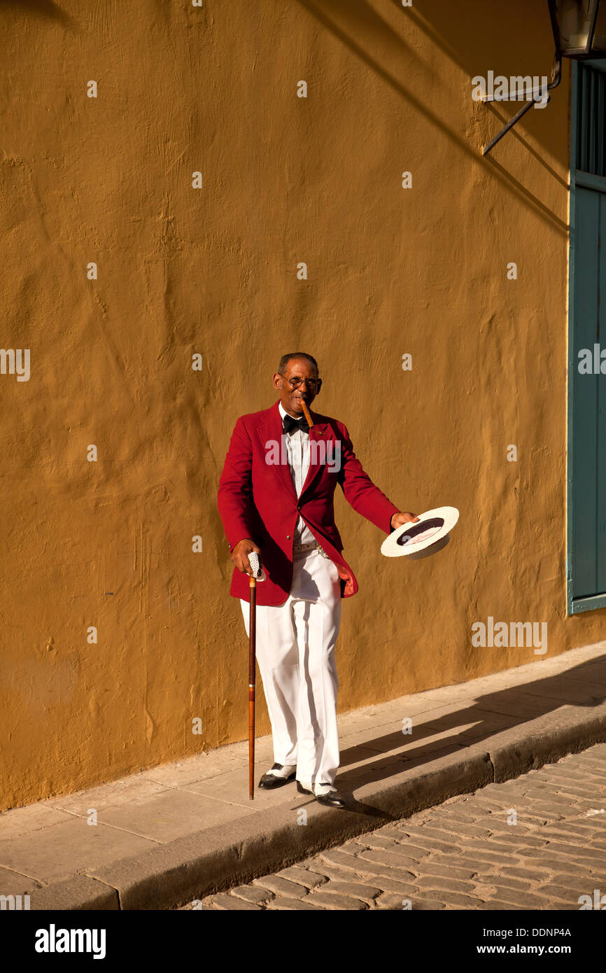 der Schauspieler Pedro Pablo Perez mit roten Anzug, Hut und Zigarre in Havanna, Kuba, Karibik Stockfoto