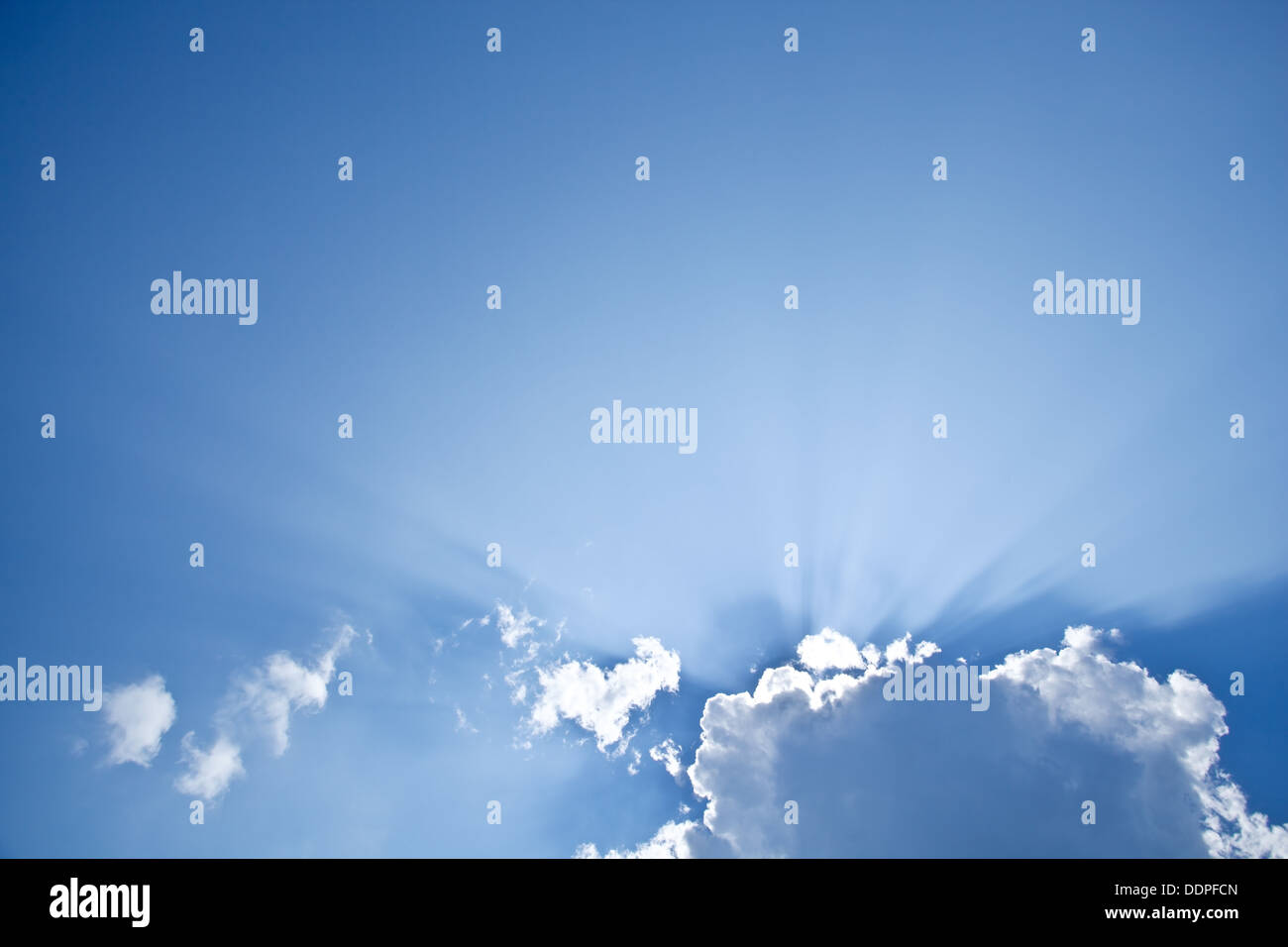 Strahlen der Sonne hinter den Wolken spähen. Stockfoto