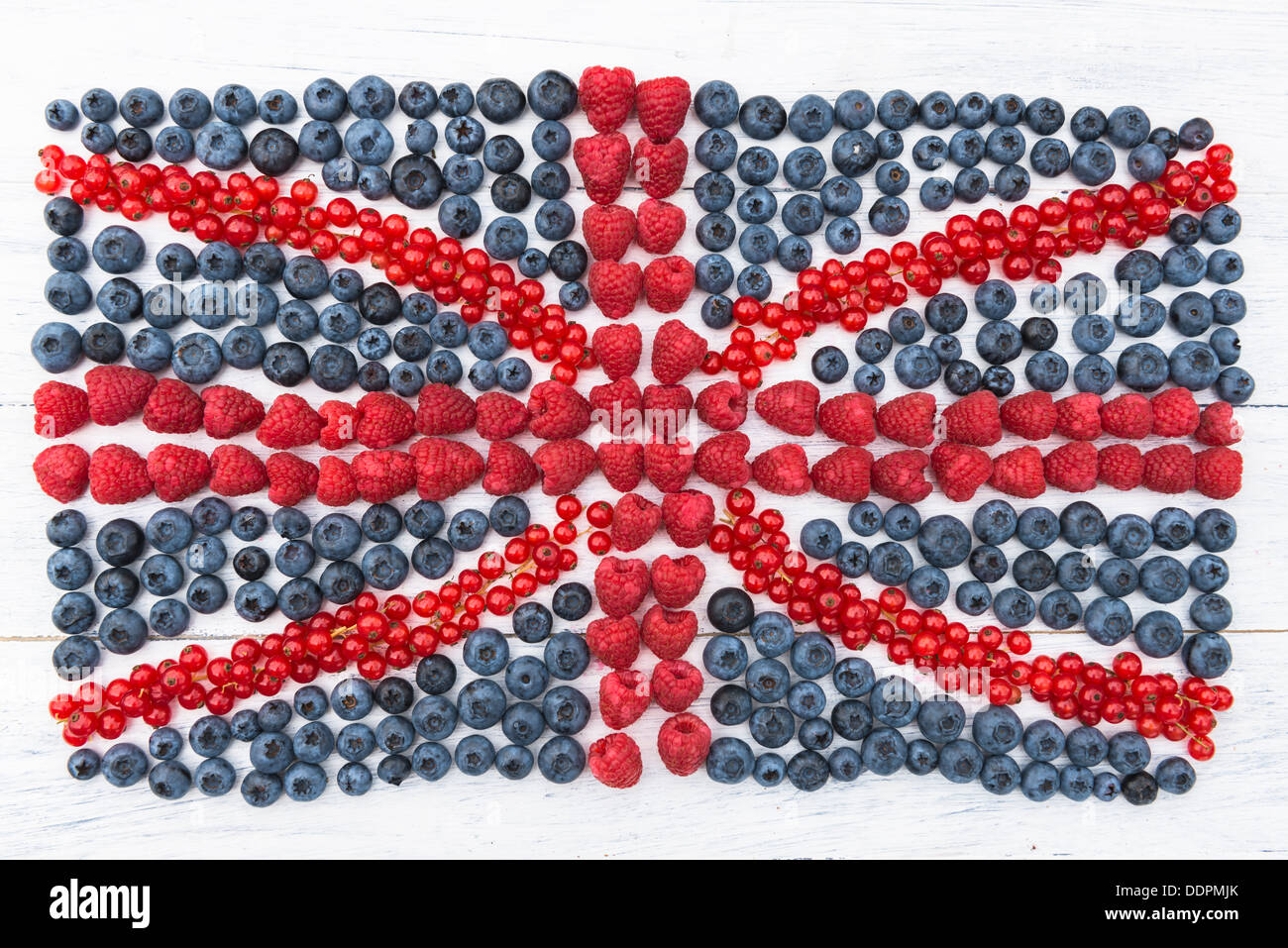 Sommer-Obst - Himbeeren, Heidelbeeren und roten Strom auf weißen Holzbrett in eine britische Flagge angeordnet Stockfoto