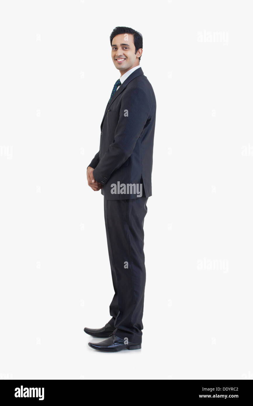 Seitenansicht der Geschäftsmann im Anzug auf grauem Hintergrund isoliert Stockfoto