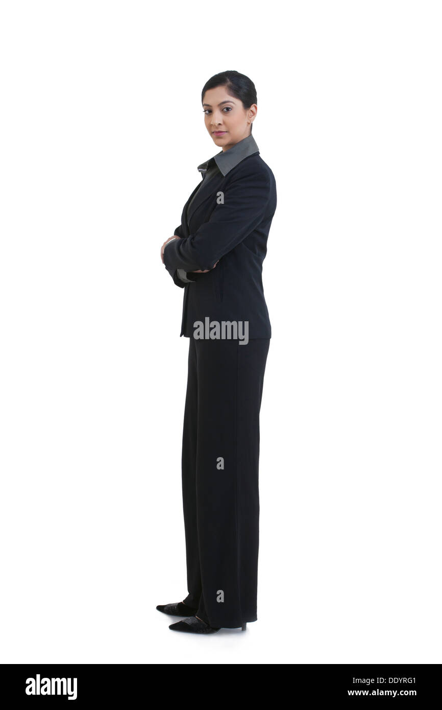 Seitenansicht des zuversichtlich Geschäftsfrau mit Arme gekreuzt stehend vor weißem Hintergrund Stockfoto