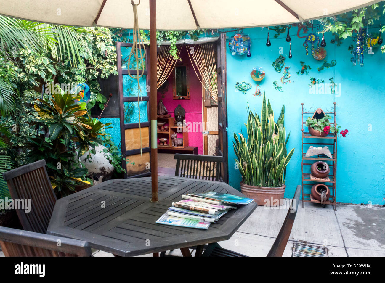 Terrassentisch und Stühle mit Sonnenschirm in einem privaten Innenhof in Ajijic. Stockfoto