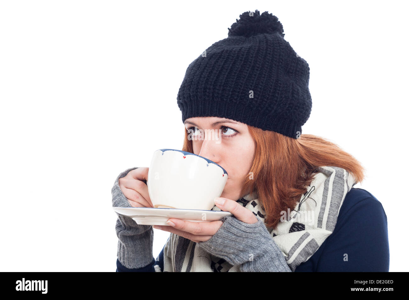 Frau in Wintermütze trinken heißen Tee oder Kaffee, isoliert auf weißem Hintergrund. Stockfoto