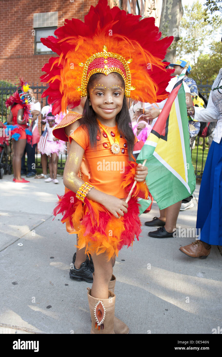 2012 West Indian/Karibik Kiddies Parade, Crown Heights. Kostümierte Mädchen hält Flagge Guyanas. Stockfoto