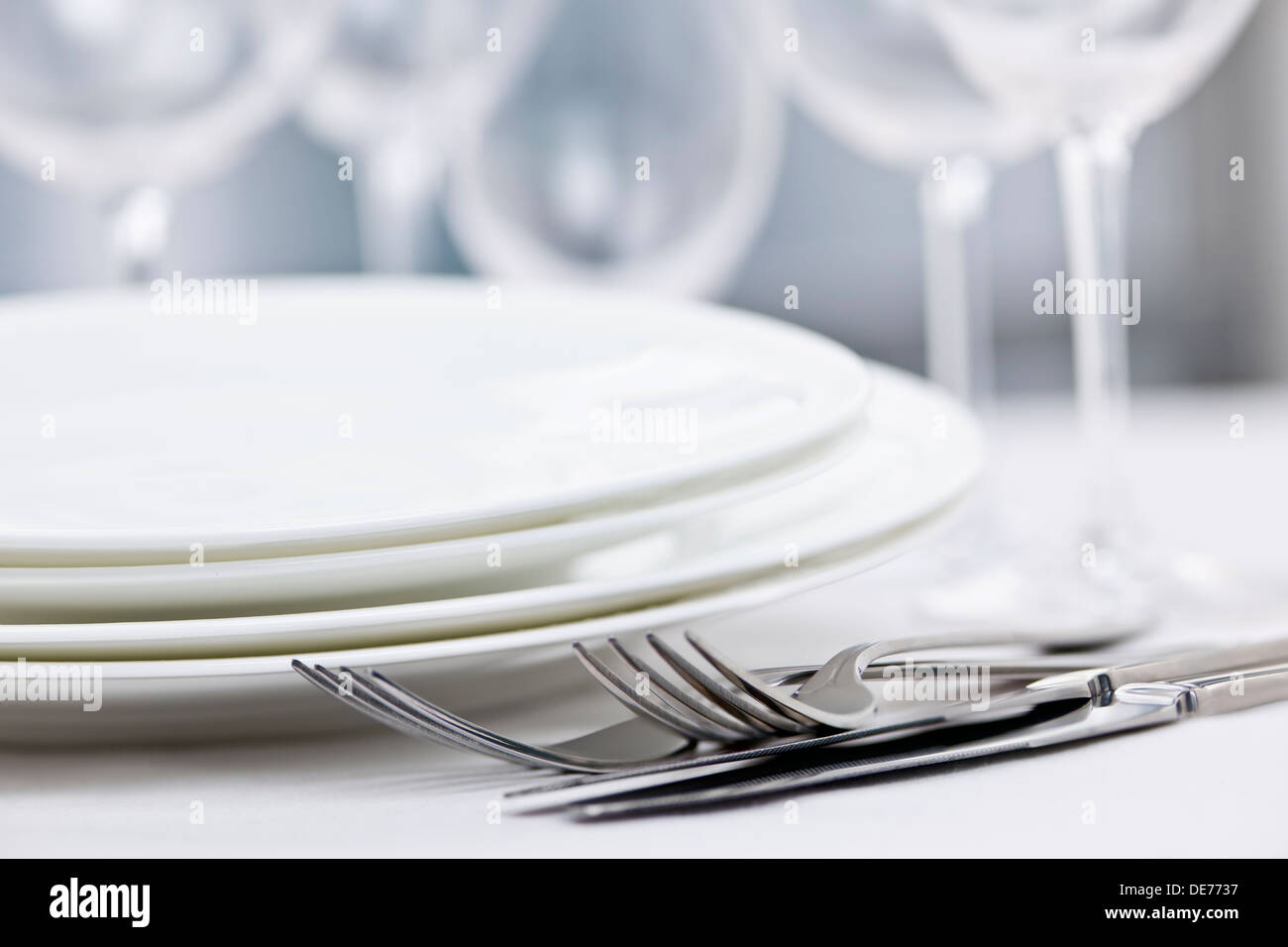 Elegantes Restaurant Tischdekoration für ein feines Abendessen mit Tellern, Besteck und Gläser Stockfoto
