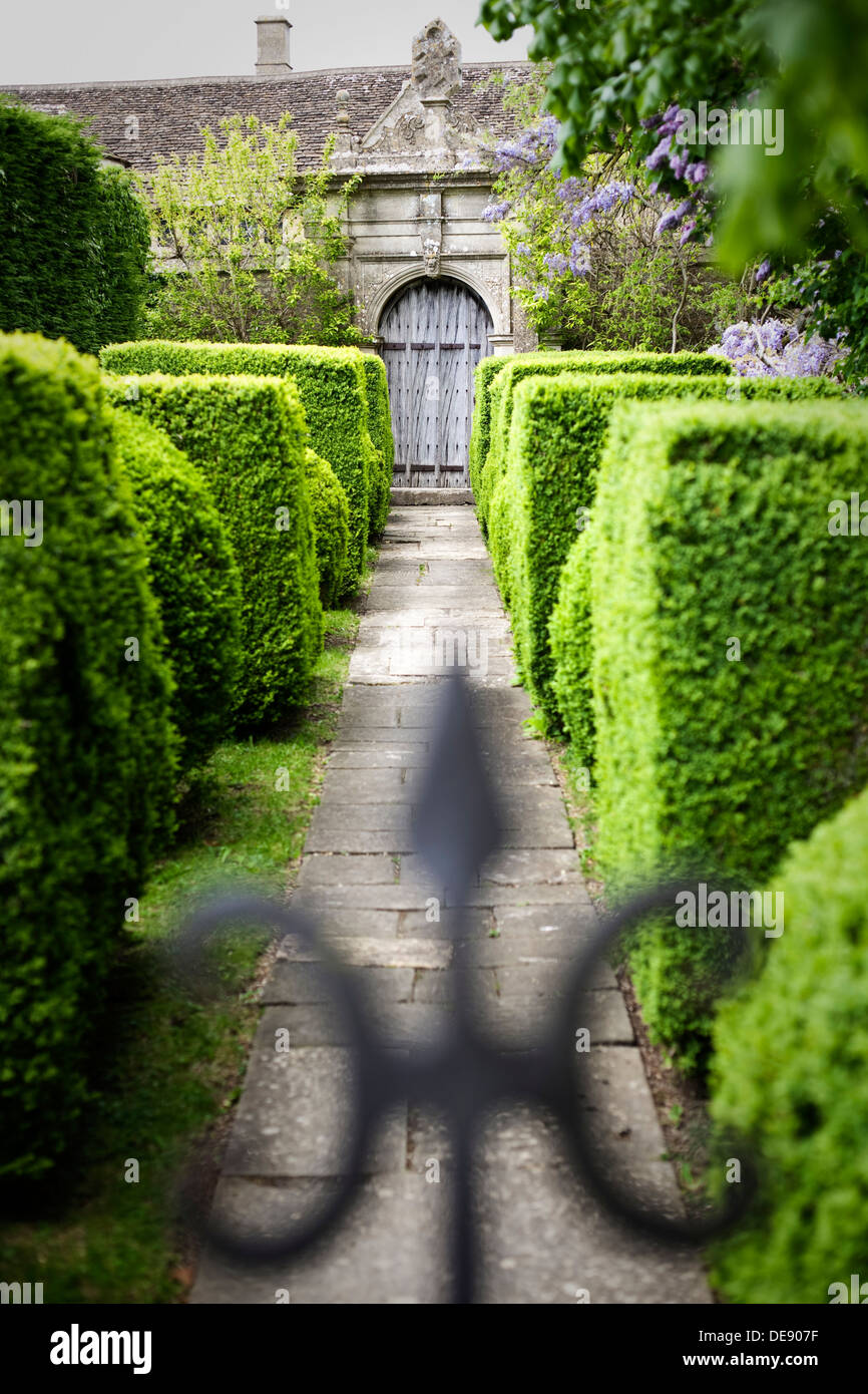 Hecke gesäumten Fußweg zu einem Tor in formalen Gärten. Stockfoto