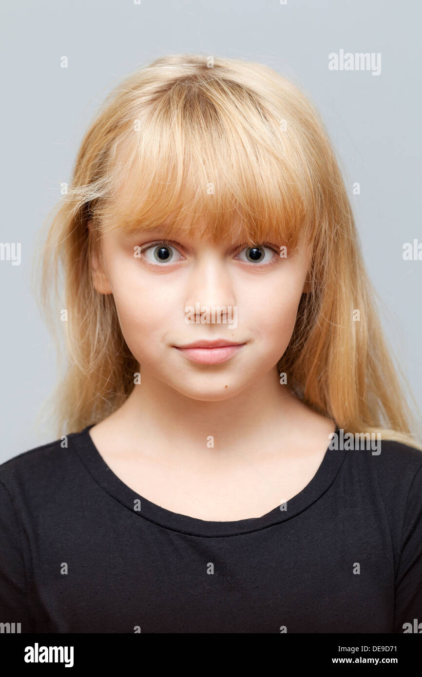 Closeup Studioportrait Gesicht des kleinen kaukasischen gewöhnliches Mädchen auf grauem Hintergrund isoliert Stockfoto