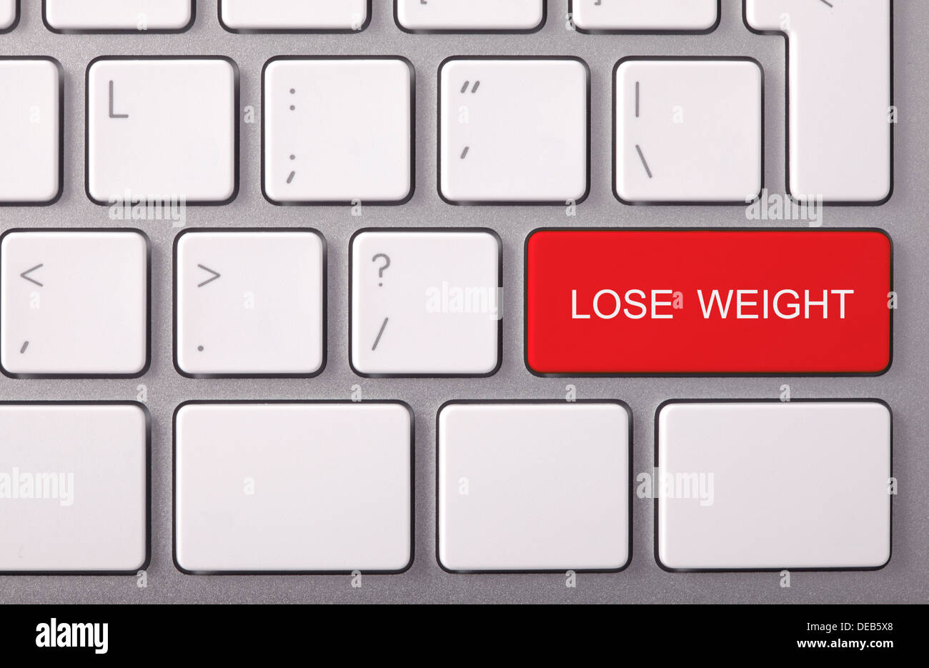 Laptop-Tastatur und rote Taste "Gewicht verlieren" drauf Stockfoto
