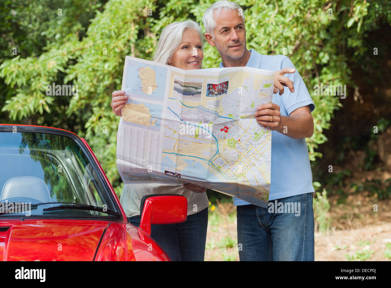 Älteres paar lesen Karte Suche nach Richtung Lächeln Stockfoto