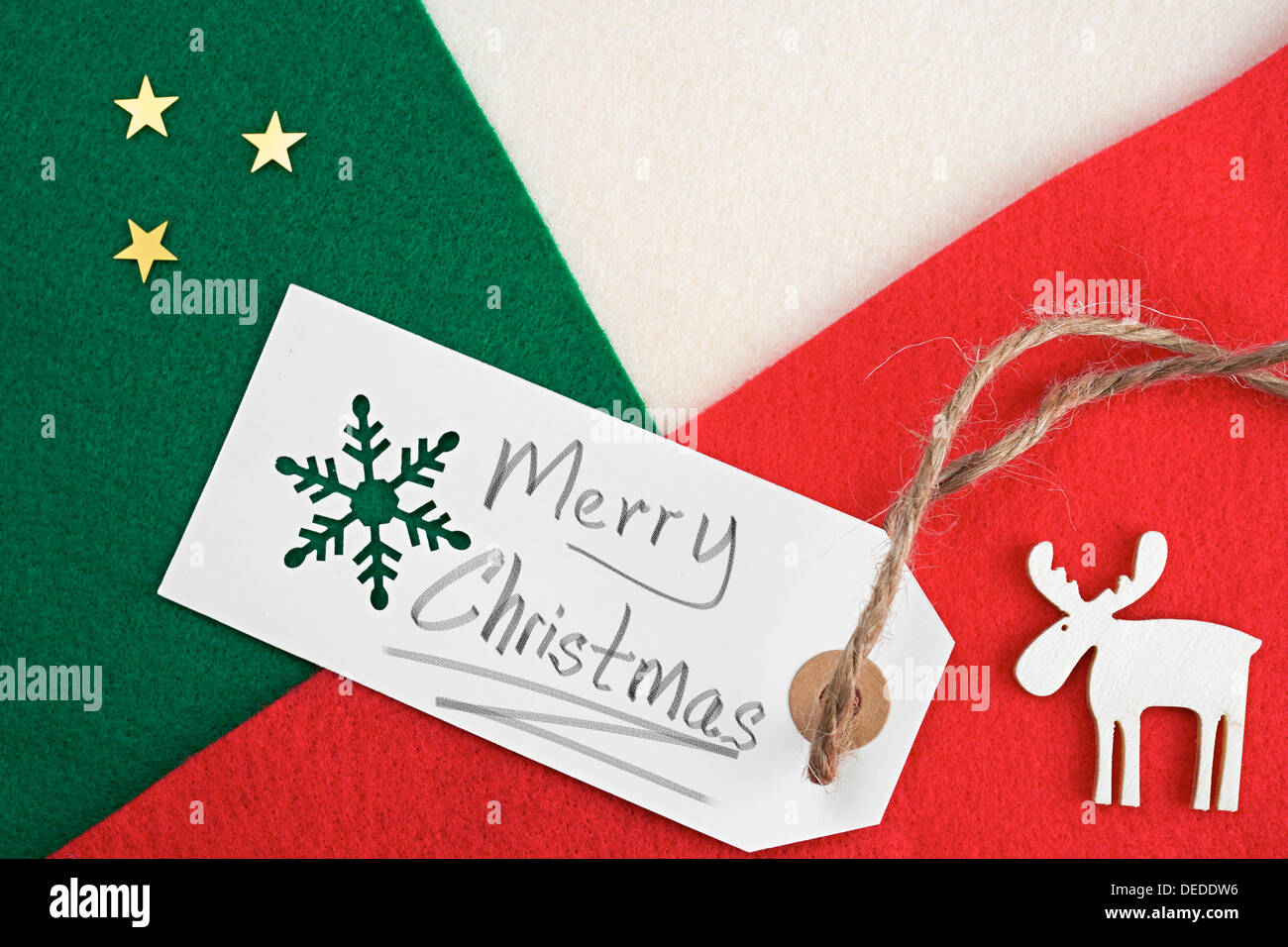 Weihnachten Geschenkanhänger auf ein rot, grün und Creme fühlte materiellen Hintergrund. Stockfoto