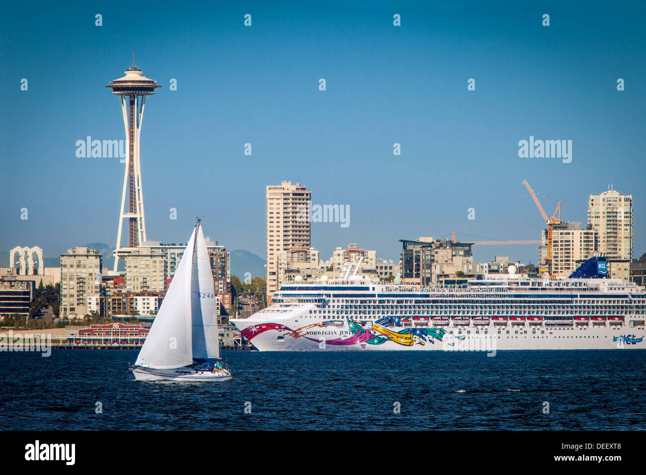 Segelboot und Kreuzfahrt Schiff unterhalb der Space Needle in Seattle, Washington, USA Stockfoto