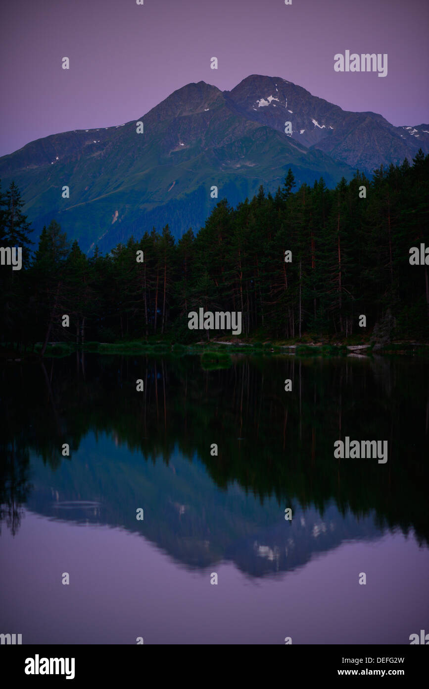 Nadelwald am Möserer See, lila Himmel sehen, der Rietzer Grieskogel oder Rietzer Griesskogel Berg an der Rückseite, in der Nähe von Mösern Stockfoto