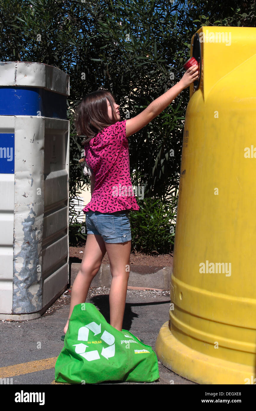 Ein junges Mädchen (7 bis 8 Jahre), recycling eine Blechdose Stockfoto