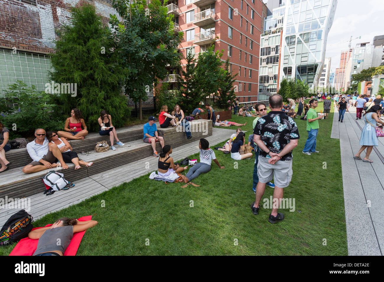 Menschen genießen einen sonnigen Tag auf der High Line Bürgerpark erhaben über die Straßen auf der West Side Manhattan Stockfoto