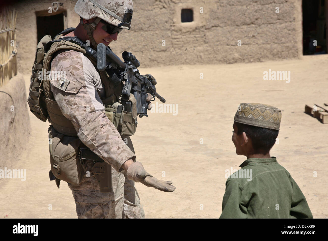 US Marine Corps 1st Lt. Michael Smith mit dem 33. georgischen Liaison Team interagiert mit einem jungen in Barrmo, Washir Bezirk, Afghanistan, 19. September 2013. Das 33. georgischen Liaison Team unterstützt georgischen und der afghanischen Nation Armeesoldaten bei der Durchführung von mount Stockfoto