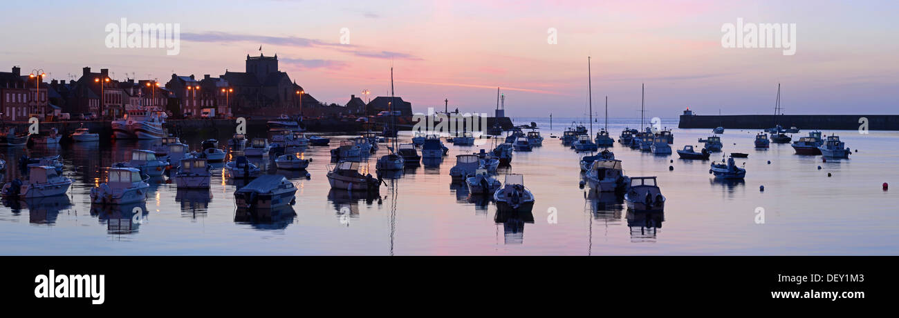 Sonnenaufgang hinter dem Hafen von Barfleur mit seinen Booten reflektiert in dem ruhigen Wasser des Ärmelkanals, Cotentin Halbinsel Stockfoto