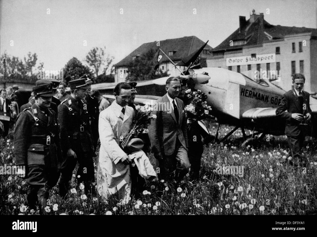 Joseph Goebbels, Center Vordergrund, trägt weißen Trenchcoat und hält Blumen, am Flughafen Königsberg, Ostpreußen, 1933 Stockfoto