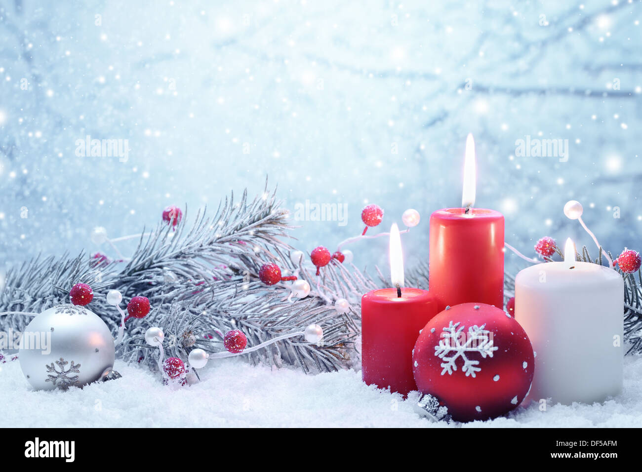 Weihnachts-Dekoration mit Kerzen, Tanne Zweig und Kugeln auf Schnee. Stockfoto