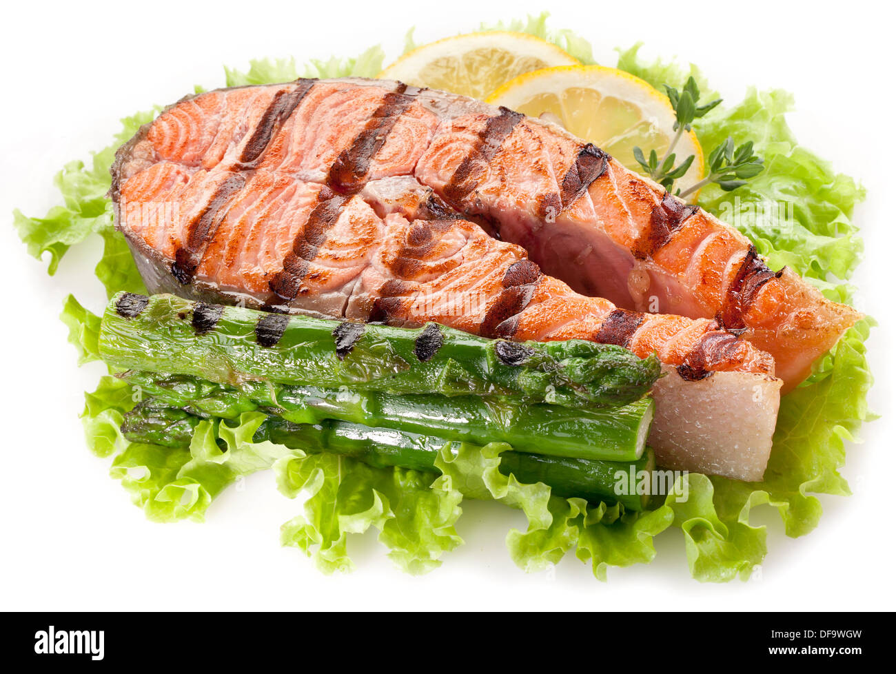 Gegrillter Lachs und Spargel auf Salat Blätter auf einem weißen Hintergrund. Stockfoto