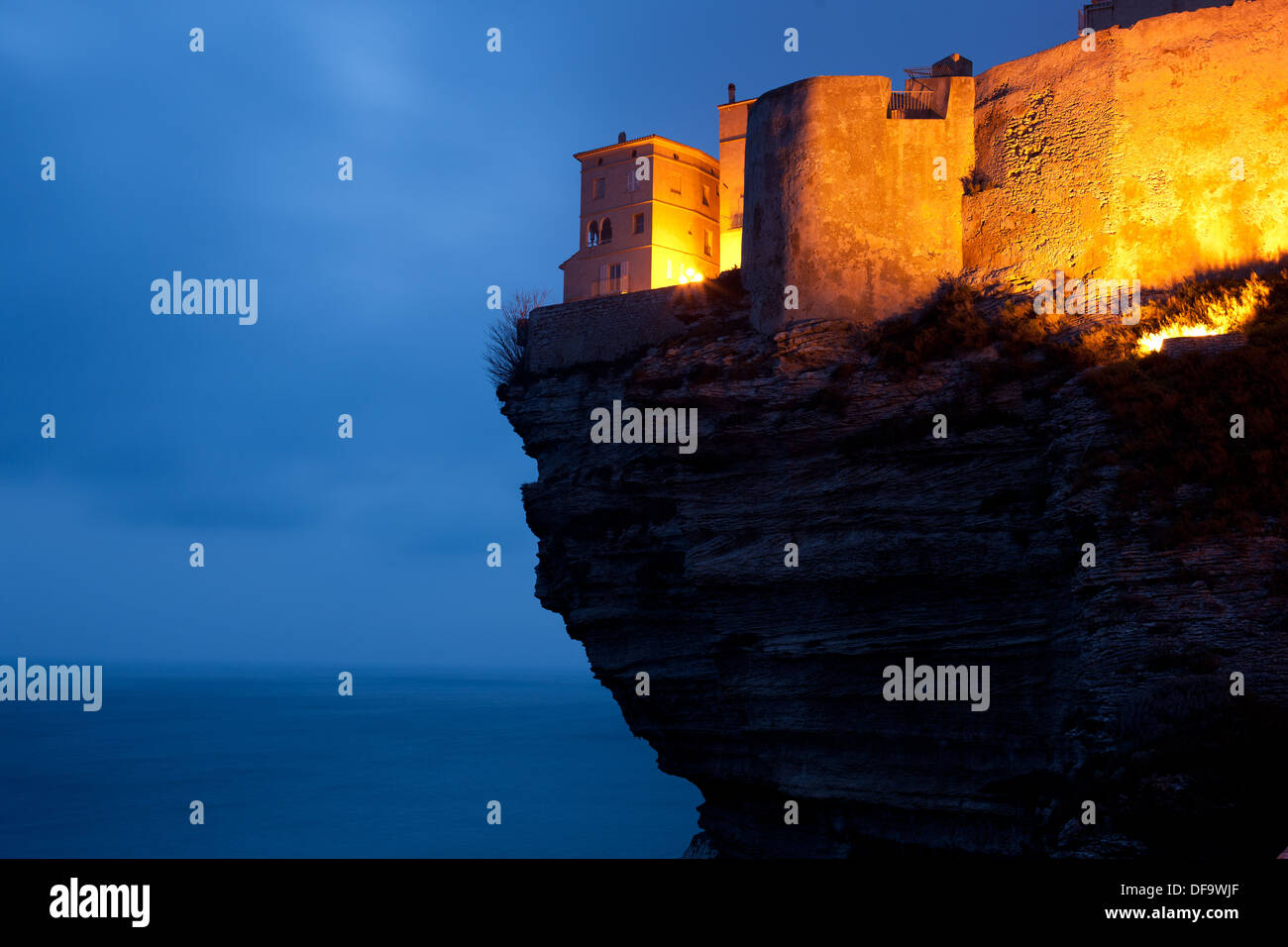 Zeitbelichtung in der Dämmerung einer Zitadelle, die über einem unglaublichen Überhang errichtet wurde. Bonifacio, Korsika, Frankreich. Stockfoto