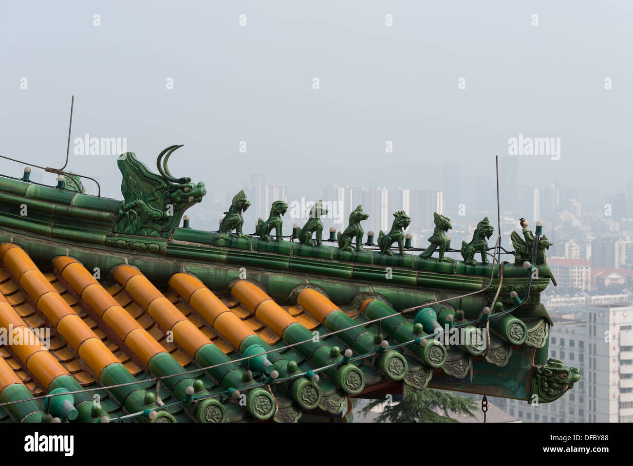 Yuejiang Lou, Nanjing, China. Detail eines Dachs auf der Yuejiang Lou mit Blick auf die Skyline einer nebligen Nanjing. Stockfoto