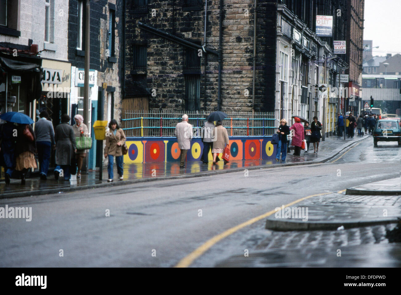 Fußgänger vorbei an bunt gemalten Tafeln des Künstlers Walter Kershaw auf einem Rochdale Straße 1970 s Lancashire GROSSBRITANNIEN 1975 KATHY DEWITT Stockfoto