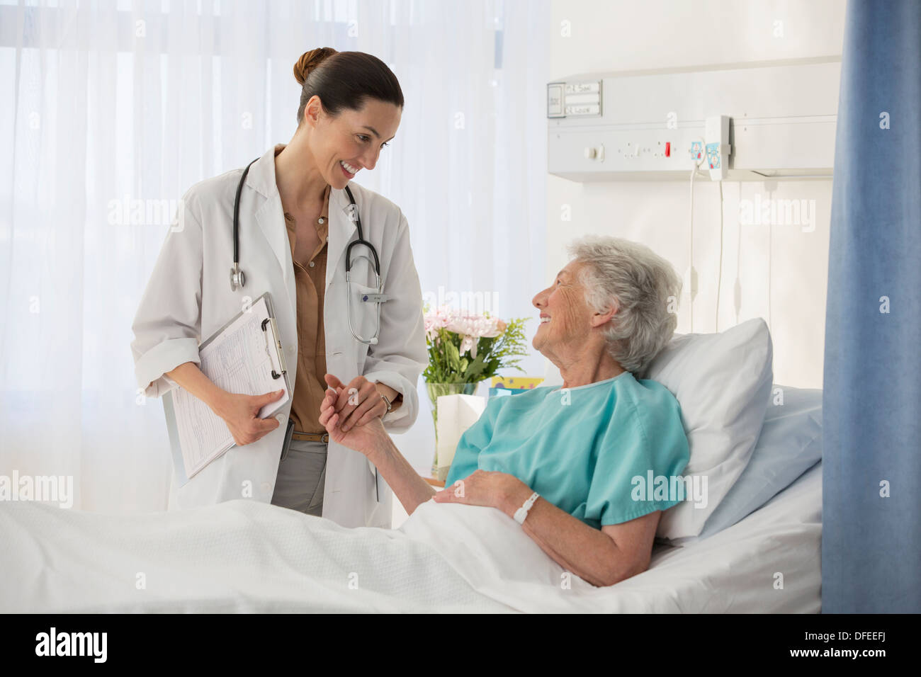 Arzt und Senior Patient im Krankenzimmer im Gespräch Stockfoto
