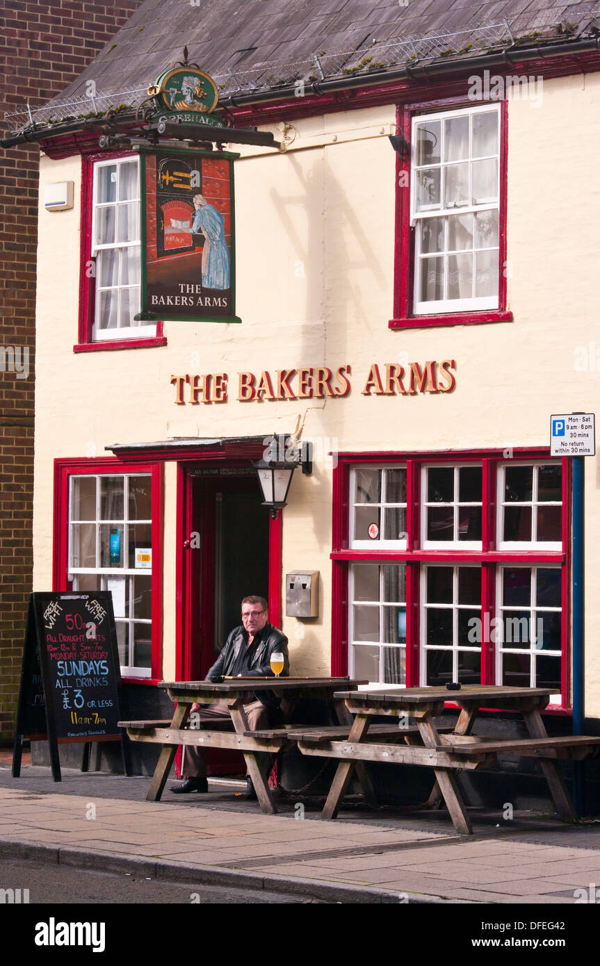 Mann sitzt außerhalb der Bäcker Arms Pub bei einem Drink UK Stockfoto