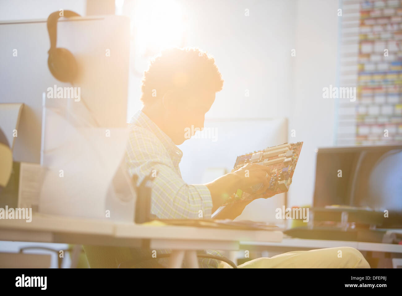 Geschäftsmann, die Platine in sonnigen Büro halten Stockfoto