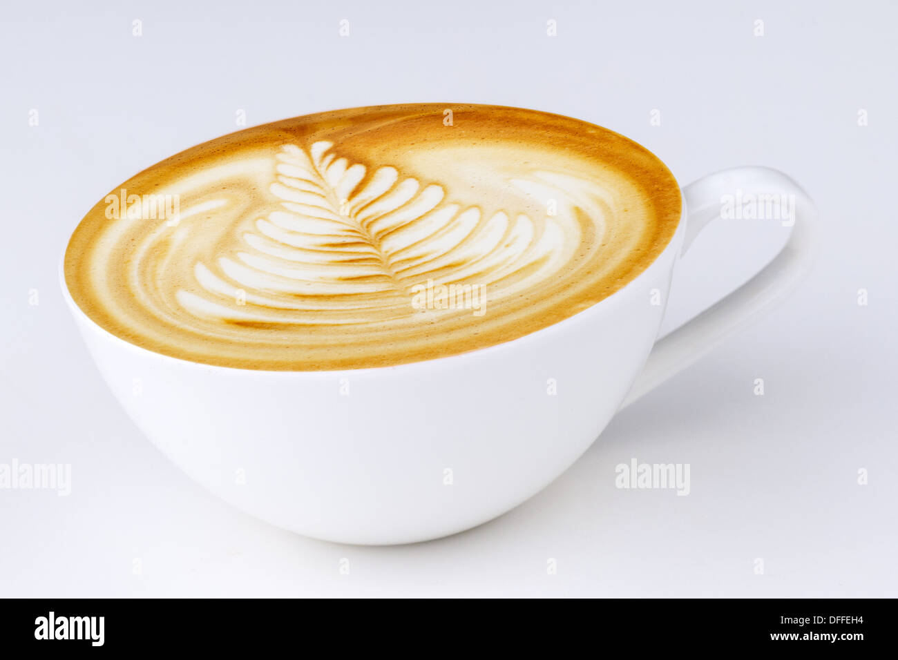 Cappuccino in einer weißen Tasse auf einem weißen Hintergrund Stockfoto