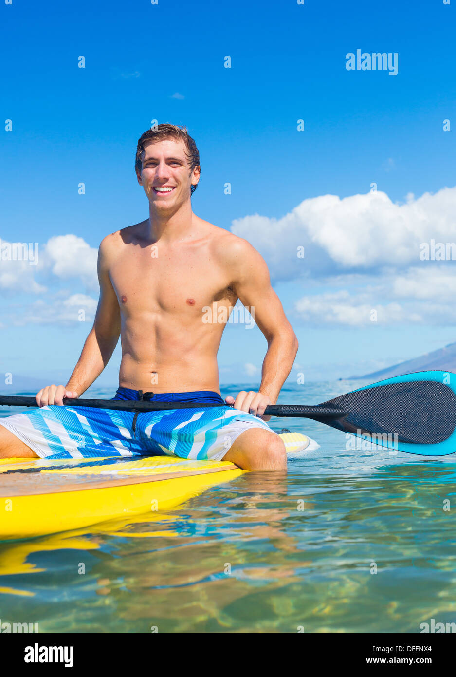 Attraktive junge Mann Stand Up Paddle Surfen In Hawaii, schönen tropischen Ozean aktiv Strand Lebensstil Stockfoto
